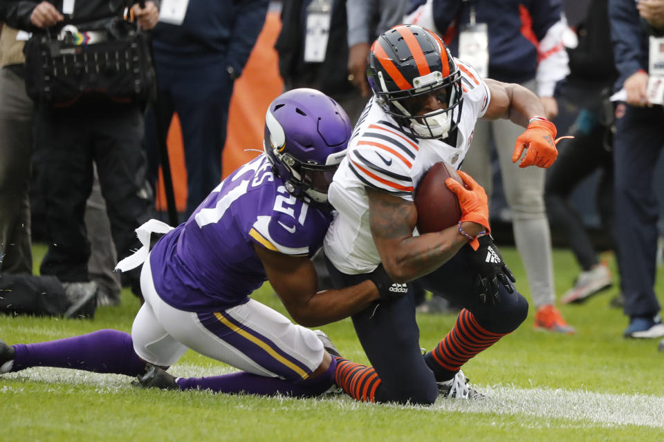 Chicago Bears wide receiver Allen Robinson, right, is pulled down by Minnesota Vikings cornerback Mike Hughes (21) after catching a pass during the half of an NFL football game Sunday, Sept. 29, 2019, in Chicago. (AP Photo/Charles Rex Arbogast)