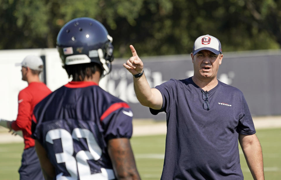 Houston Texans coach Bill O'Brien, right, talks to cornerback Lonnie Johnson Jr. (32) during an NFL football training camp practice Thursday, July 25, 2019, in Houston. (AP Photo/David J. Phillip)