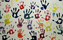 Hand prints representing migrant children line a hall at a "tender-age" facility for babies, in Texas' Rio Grande Valley, Thursday, Aug. 29, 2019, in San Benito, Texas. Sheltering migrant children has become a booming business for Comprehensive Health Services, a Florida-based government contractor, as the number of children in government custody has swollen to record levels over the past two years. (AP Photo/Eric Gay)