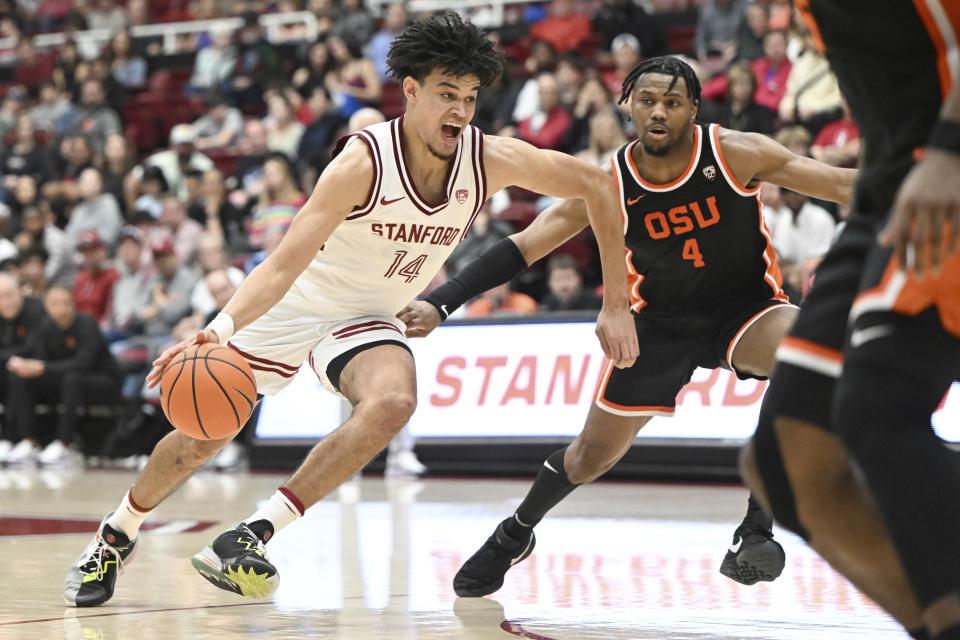 Stanford forward Spencer Jones (14) drives the ball past Oregon State guard Dexter Akanno (4) during the second half of an NCAA college basketball game Saturday, Feb. 24, 2024, in Stanford, Calif. (AP Photo/Nic Coury)