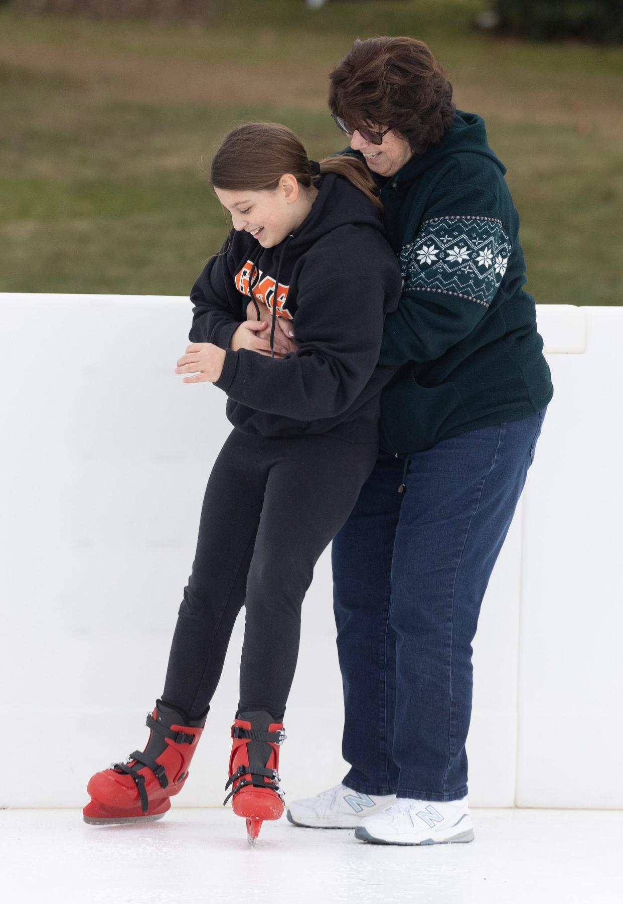 Nancy Hawk of Brewster helps her granddaughter Ava Hawk, 11, of Massillon as she learns to skate at Wampler Park in Massillon.