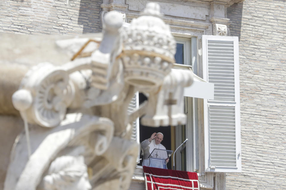 Pope Francis delivers his blessing as he recites the Angelus noon prayer from the window of his studio overlooking St.Peter's Square, at the Vatican, Sunday, June 7, 2020. Pope Francis is cautioning people in countries emerging from lockdown to keep following authorities’ rules for COVID-19 contagion containment. Says Francis: “Be careful, don’t cry victory, don’t cry victory too soon.” (AP Photo/Andrew Medichini)