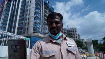 Kajima employee Gunasekar Udayakumar uses the Nervotec app to scan his face and check his vital signs as part of a daily checkup for employees at a construction site in central Singapore