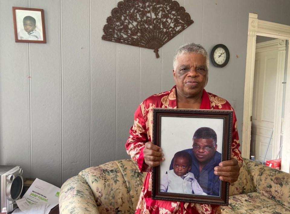 man holding up a photo of him and quawan