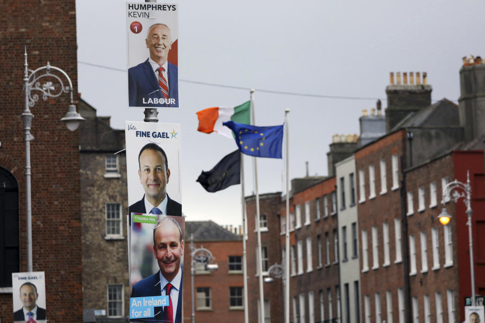 Election posters are displayed on lampposts outside the Irish Prime Minister offices in Dublin, Ireland, Friday, Feb. 7, 2020. Irish voters will choose a new parliament on Saturday, and may have bad news for the two parties that have dominated the country’s politics for a century, Fianna Fail and Fine Gael. Polls show a surprise surge for Sinn Fein, the party historically linked to the Irish Republican Army and its violent struggle for a united Ireland. (AP Photo/Peter Morrison)