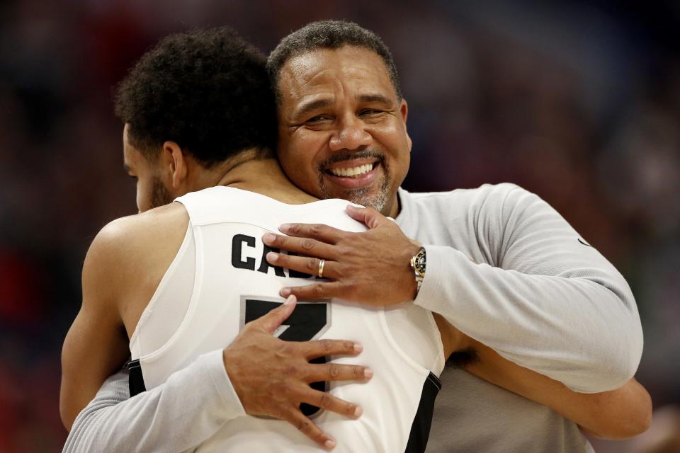 Head coach Ed Cooley of the Providence Friars smiles as he hugs Matteus Case (3) of the Providence Friars during the second half against the Richmond Spiders in the second round game of the 2022 NCAA Men's Basketball Tournament at KeyBank Center on Saturday, March 19, 2022, in Buffalo, New York. (Joshua Bessex/Getty Images/TNS) ORG XMIT: 43130249W