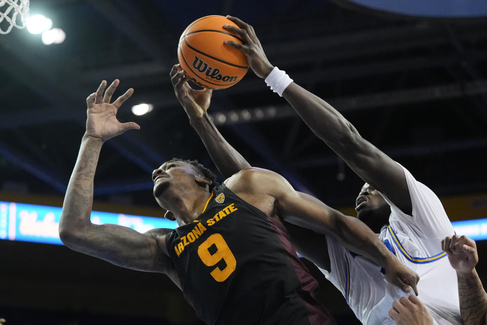 UCLA forward Adem Bona, right, jumps for a rebound next to Arizona State center Shawn Phillips Jr. during the second half of an NCAA college basketball game in Los Angeles, Saturday, March 9, 2024. (AP Photo/Jae C. Hong)