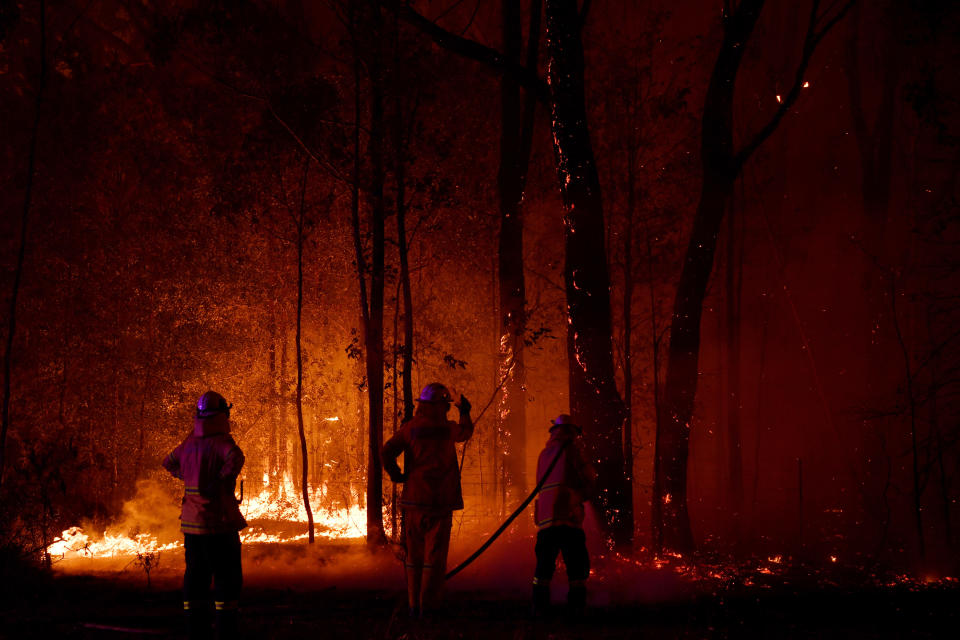 Firefighters are seen battling a bushfire on New Year's Eve. Source: Sam Mooy/Getty