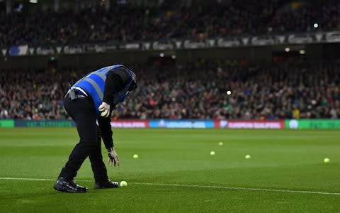 Soccer Football - Euro 2020 Qualifier - Group D - Republic of Ireland v Georgia - Aviva Stadium, Dublin, Republic of Ireland - March 26, 2019 Stewards clear tennis balls thrown onto the pitch  - Credit: REUTERS