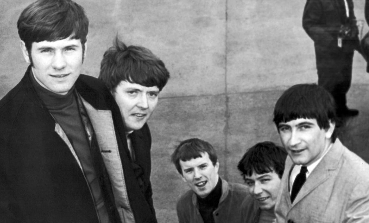 FILE - In this May 27, 1965 file photo, The Animals, from left, Hilton Valentine, Chas Chandler, John Steel, Eric Burdon and Dave Rowberry, board an airliner at London Airport, bound for New York where they will appear on "The Ed Sullivan Show". Hilton Valentine, the founding guitarist of English rock and roll band The Animals who is credited with coming up with one of the most famous opening riffs of the 1960s, has died. He was 77. The band’s label ABKCO Music confirmed that Valentine died on Friday, Jan. 29, 2021 saying it was informed of the death by his wife Germaine Valentine. (AP Photo/Victor Boynton, FIle)