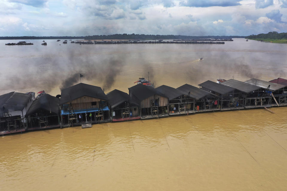 FILE - Dredging barges operated by miners illegally mining gold converge on the Madeira River, a tributary of the Amazon river in Autazes, Amazonas state, Brazil, Nov. 25, 2021. One of Brazil’s biggest gold refiners, which has been accused of processing gold mined illegally deep in the Amazon rainforest, has been stripped of an important industry certification that global manufacturers from Apple to Tesla rely on to root out abuses in their supply chains. (AP Photo/Edmar Barros, File)