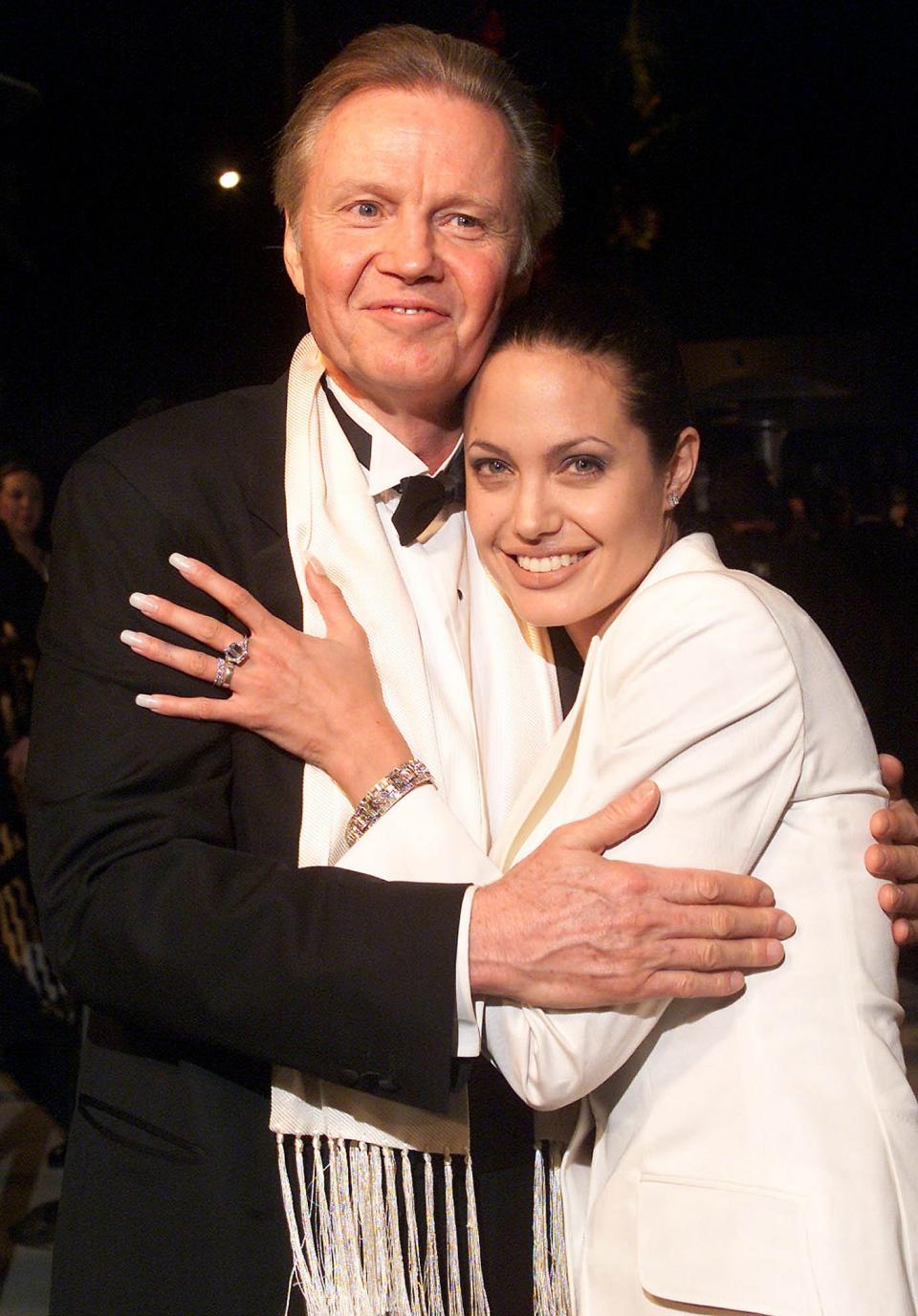 <p>The actor sang his daughter's praises as a devoted mother of six.</p> <p>"She loves her kids, she's always involved with them, always concerned for them," Voight <a href="https://people.com/movies/jon-voight-what-makes-angelina-jolie-good-mom/" rel="nofollow noopener" target="_blank" data-ylk="slk:told reporters;elm:context_link;itc:0;sec:content-canvas" class="link ">told reporters</a> at pre-Golden Globes gala in January 2020. "She monitors everything. She's great."</p> <p><em>The Eternals</em> star and her actor father were <a href="https://people.com/archive/angelina-jolie-dad-jon-voight-ending-their-feud-vol-73-no-10/" rel="nofollow noopener" target="_blank" data-ylk="slk:estranged for nearly seven years;elm:context_link;itc:0;sec:content-canvas" class="link ">estranged for nearly seven years</a> before <a href="https://people.com/movies/angelina-jolie-jon-voight-first-they-killed-my-father-premiere-nyc" rel="nofollow noopener" target="_blank" data-ylk="slk:ending their feud;elm:context_link;itc:0;sec:content-canvas" class="link ">ending their feud</a> in 2010 at the urging of her ex-husband Brad Pitt, who convinced the actress to mend fences.</p>