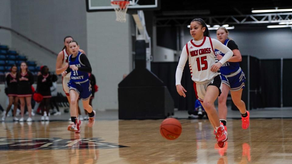 Holy Cross guard Aniyah Carter (15) pushes the ball up the court against Nicholas County in the All 'A' state semifinals on Jan. 27 at Corbin Arena in Corbin, Ky.