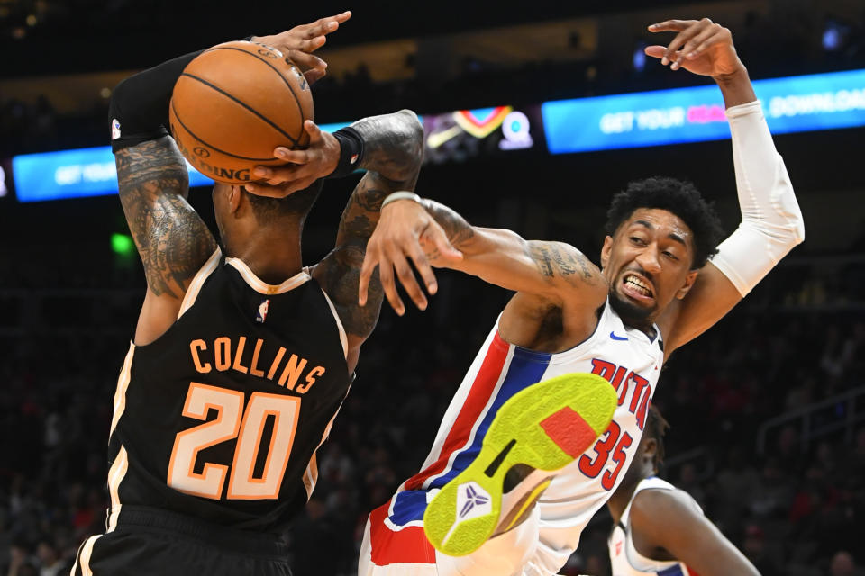 Detroit Pistons forward Christian Wood, right, comes down after blocking a shot by Atlanta Hawks forward John Collins (20) during the first half of an NBA basketball game Saturday, Jan. 18, 2020, in Atlanta. (AP Photo/John Amis)