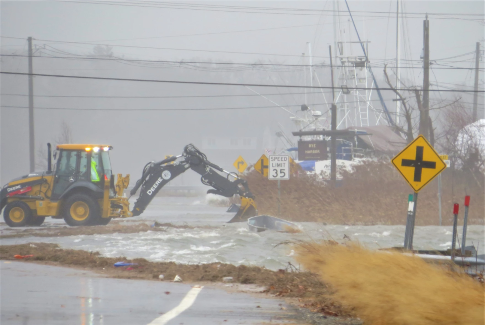 Coastal flooding closed several parts of Route 1A in Rye and North Hampton on Friday, Dec. 23, 2022. Here, at Rye Harbor, a dingy floats up along the road.