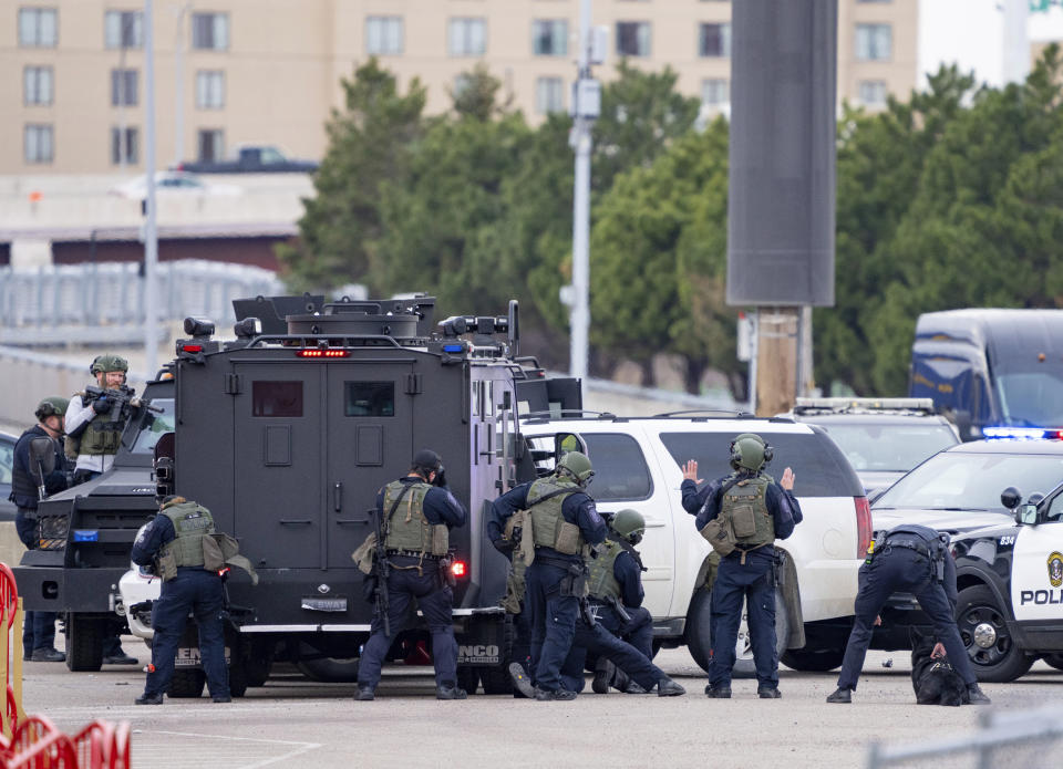 Police speak to a man in a white SUV in the North parking lot of the Mall of America Friday, April 21, 2023, in Bloomington, Minn. An area near the Mall of America was closed Friday evening as authorities were negotiating with a person was was believed to have a gun. (Alex Kormann/Star Tribune via AP)