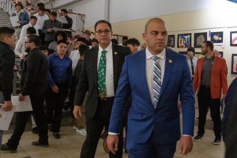 Trustees Ricardo Castellano, left, and Pablo Barrera return to the board room after taking a photo with Socorro Independent School District students during a board meeting in 2022.