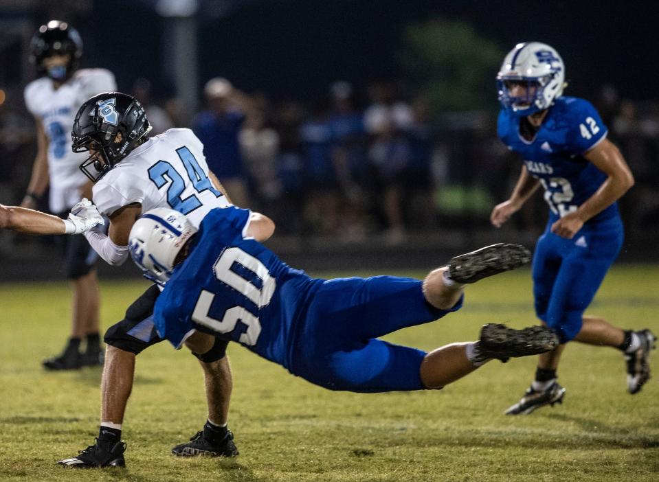 Spencer County High's Jacob Blansett dives to stop Collins's Caleb Bailey. Sept. 9, 2022