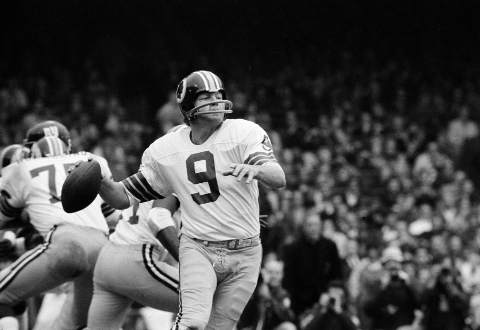 FILE - Washington quarterback Sonny Jurgensen looks to pass against the Giants during an NFL football game in 1974. The Washington Commanders will retire Pro Football Hall of Famer Sonny Jurgensen’s No. 9 later this season. The former Washington quarterback and longtime radio broadcaster will be honored in the team's regular-season finale Jan. 7 or 8 against the rival Dallas Cowboys. (AP Photo/File)