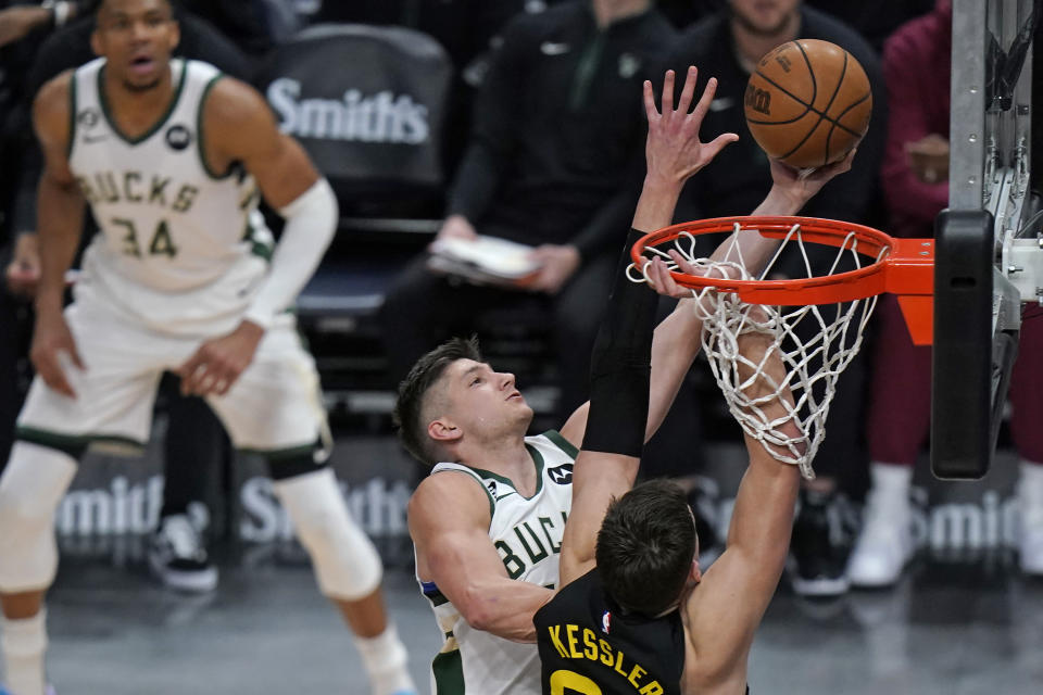 Milwaukee Bucks guard Grayson Allen goes to the basket as Utah Jazz center Walker Kessler, right, defends during the first half of an NBA basketball game Friday, March 24, 2023, in Salt Lake City. (AP Photo/Rick Bowmer)