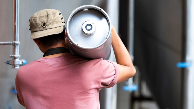 A man carrying a keg