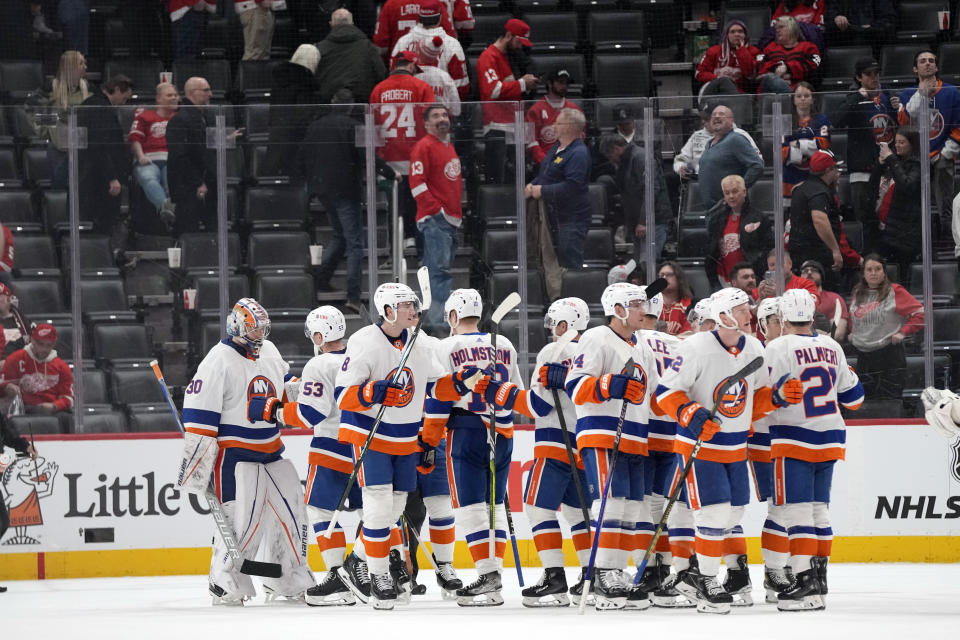 The New York Islanders greet New York Islanders goaltender Ilya Sorokin (30) after their 5-3 win after an NHL hockey game against the Detroit Red Wings, Thursday, Feb. 29, 2024, in Detroit. (AP Photo/Carlos Osorio)