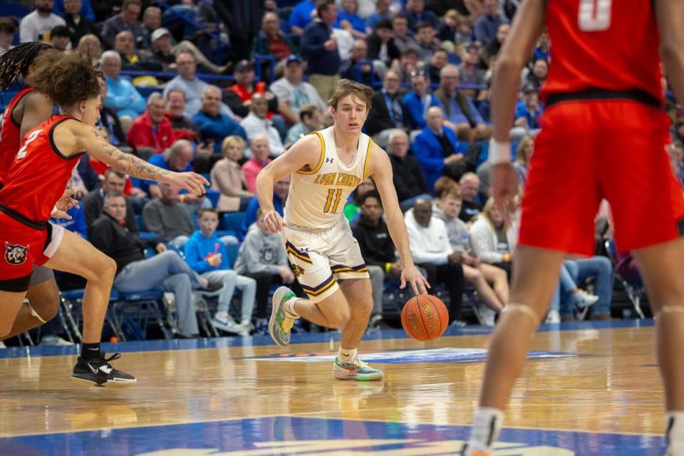 Lyon County’s Travis Perry (11) needed 21 points Thursday to break Kentucky’s all-time boys’ basketball scoring record. He finished with 23 in the Lyons’ win over Newport in Rupp Arena.