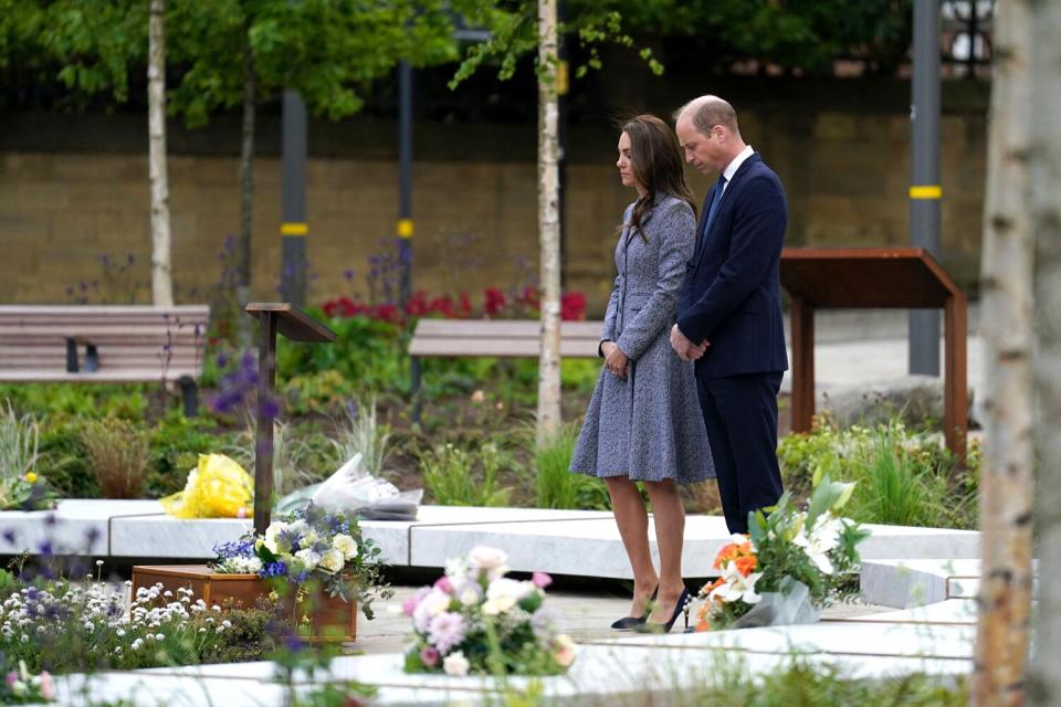 Catherine, Duchess of Cambridge (L) and Britain's Prince William, Duke of Cambridge (R) stand in silence having laid flowers at the official opening of the Glade of Light memorial