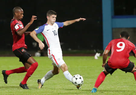United States' Christian Pulisic and Trinidad's Kevan George and Shahdon Winchester in action. REUTERS/Andrea de Silva