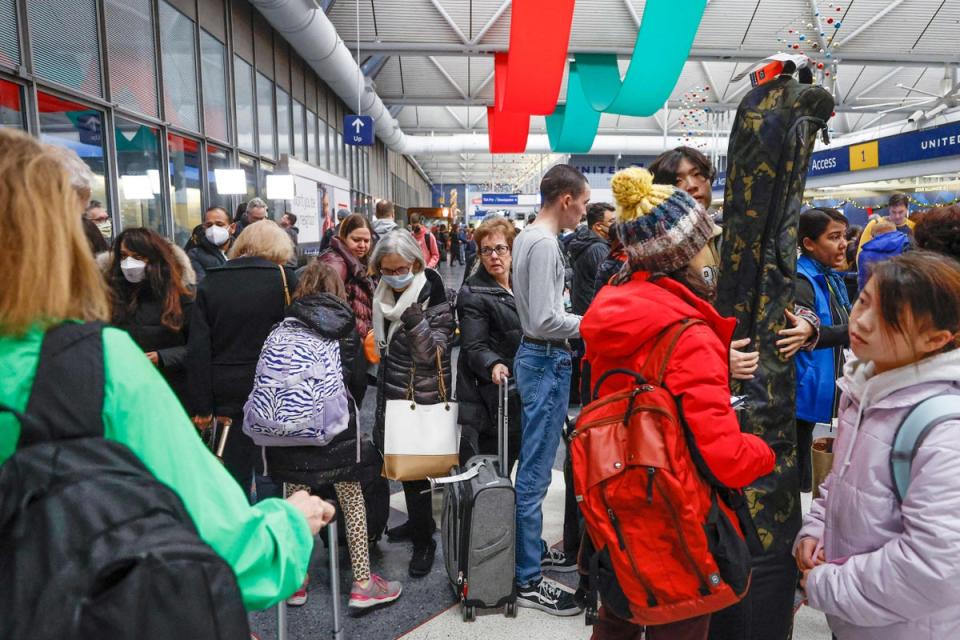 Travellers arrive for their flights at United Airlines Terminal 1 ahead of the Christmas Holiday at O’Hare International Airport (AFP/Getty)