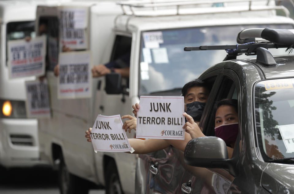 Protesters wearing protective masks hold slogans during a rally from inside their vehicles calling on legislators to junk the proposed anti-terror bill in front of the House of Representatives in Manila, Philippines on Wednesday, June 3, 2020. Several protesters held the rally despite a ban in mass gatherings as the government shifts to a more relaxed lockdown to prevent the spread of the new coronavirus. (AP Photo/Aaron Favila)