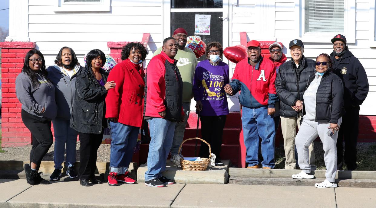 Family and friends pose with Earlene Fullwood, center, during a drive-by 100th birthday celebration on Sunday, Feb. 11, 2024, in front of her home on East Summit Street in Alliance.