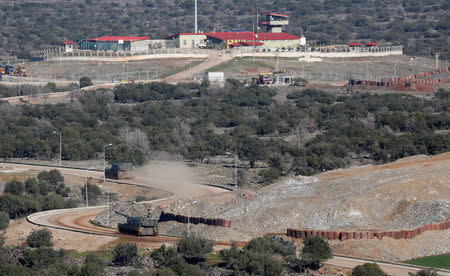 Armored Turkish army vehicles drive to a military post near the town of Hassa on the Turkish-Syrian border in Hatay province, Turkey January 20, 2018. REUTERS/Osman Orsal