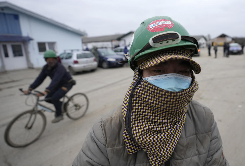 Vietnamese workers ride bicycles on their way to start their working day at the first Chinese car tire factory in Europe near the northern Serbian town of Zrenjanin, 50 kilometers north of Belgrade, Serbia, Thursday, Nov. 18, 2021. Reports have emerged in Serbia of prison-like conditions for some 500 of them at the construction site in north of the country where China's Shandong Linglong Tire Co is building the huge factory. Populist-run Serbia is a key spot for China's expansion and investment policies in Europe and Chinese companies have kept a tight lid on their projects in the country amid reports of disrespect of the Balkan nation's anti-pollution laws and labor regulations. (AP Photo/Darko Vojinovic)