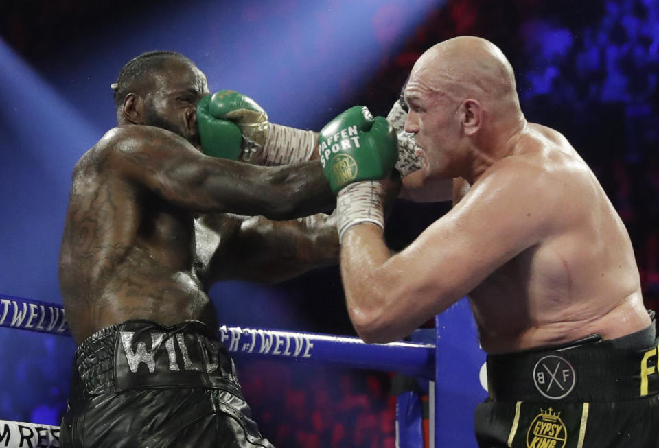 Tyson Fury, of England, lands a right to Deontay Wilder during a WBC heavyweight championship boxing match Saturday, Feb. 22, 2020, in Las Vegas. (AP Photo/Isaac Brekken)