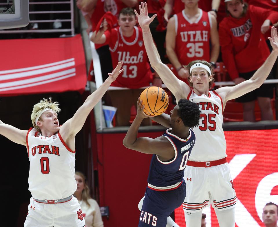 Utah Utes guard Hunter Erickson (0) and Utah Utes center Branden Carlson (35). Defied Arizona Wildcats guard Jaden Bradley (0) in Salt Lake City on Thursday, Feb. 8, 2024. Arizona Wildcats won 105-99 in triple overtime. | Jeffrey D. Allred, Deseret News