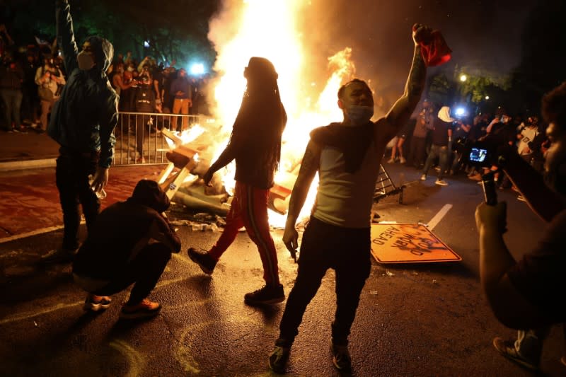 Protesters rally around a bonfire in the midst of protests against the death in Minneapolis police custody of George Floyd near the White House in Washington