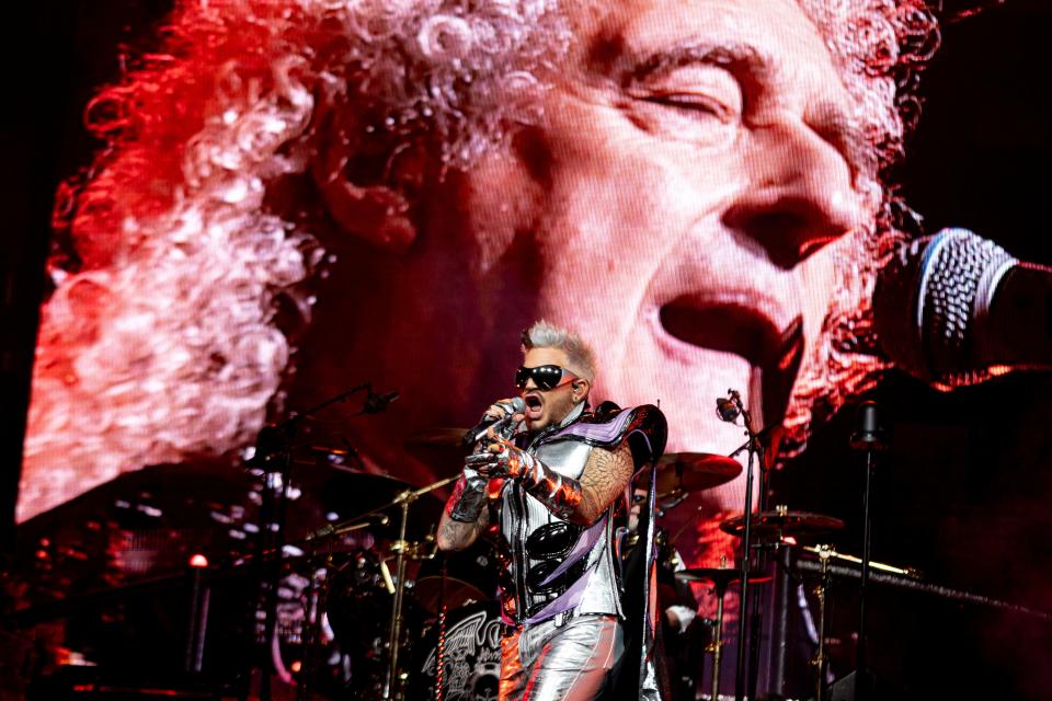 Adam Lambert, bottom, and Brian May, seen on screen, kicked off the latest run of the Rhapsody tour with original drummer Roger Taylor, on Oct. 4, 2023 in Baltimore.