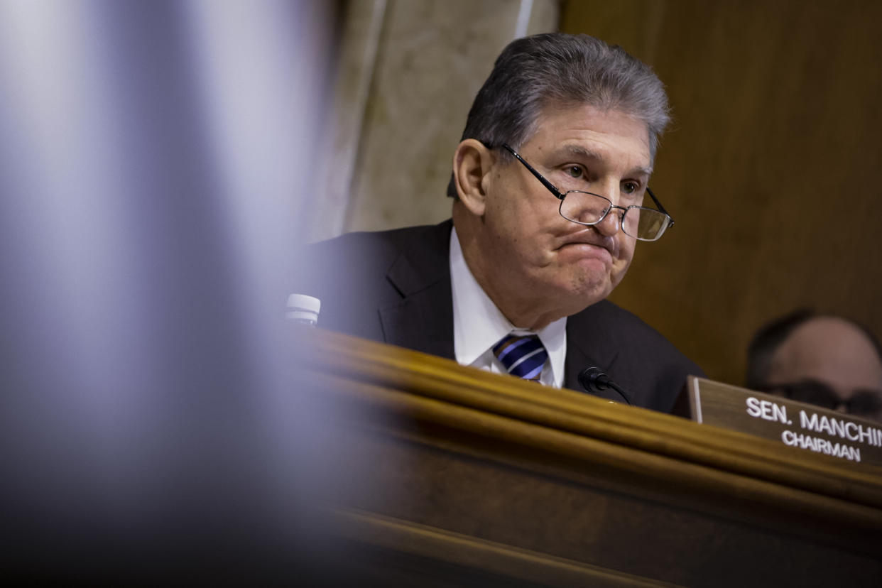 Senator Joe Manchin sits at a desk while attending a hearing in Washington.