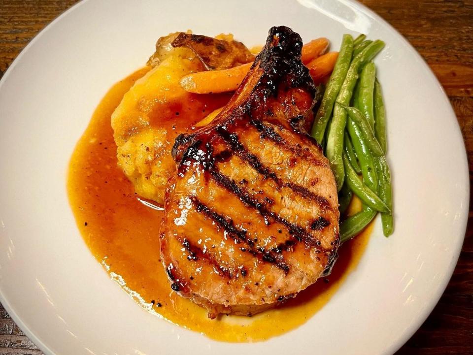Southern Social in Vero Beach features a grilled pork chop with a smashed cheddar potato and ginger glaze.