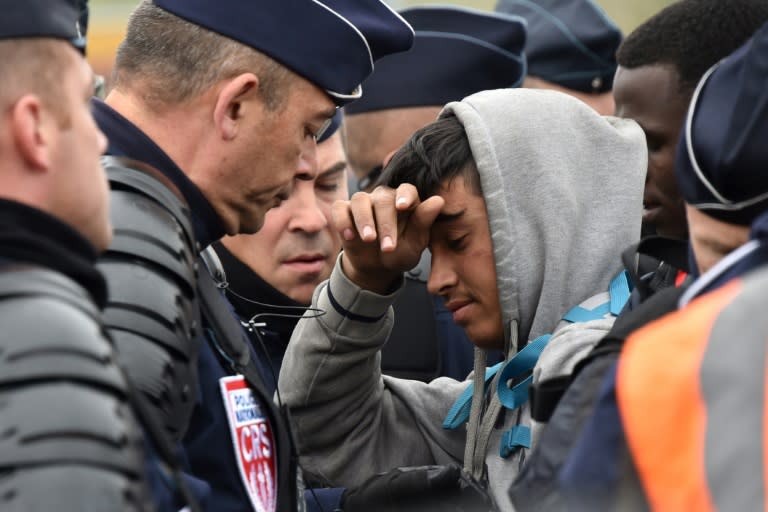 A migrant argues with French riot police at the "Jungle" camp in Calais, on October 24, 2016