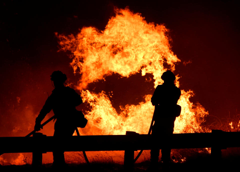 Firefighters battle a fire, as a wind driven wildfire continues to burn in Canyon Country north of Los Angeles, California, U.S. October 25, 2019. REUTERS/Gene Blevins