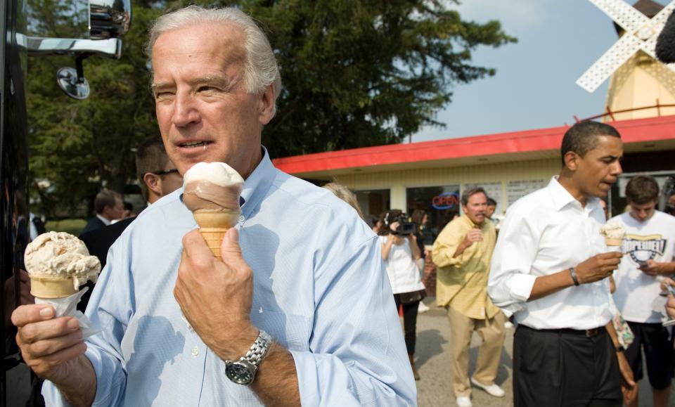 Then-vice presidential nominee Sen. Joe Biden (left) and then-presidential nominee Sen. Barack Obama enjoy ice cream cones as they speak with local residents at the Windmill Ice Cream Shop in Aliquippa, Pennsylvania, August 29, 2008.