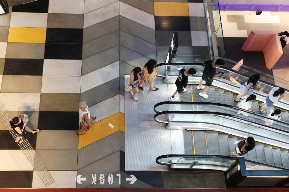 People wearing face masks as a preventive measure against the spread of Covid-19 are seen at a shopping mall.