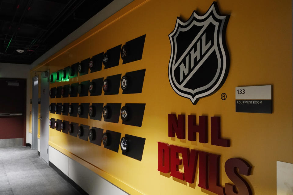 A hallway leads to the ice at the new Mullett Arena, the Arizona Coyotes NHL hockey team's new temporary home, Monday, Oct. 24, 2022, in Tempe, Ariz. The Coyotes will be sharing arena with Arizona State University. (AP Photo/Ross D. Franklin)