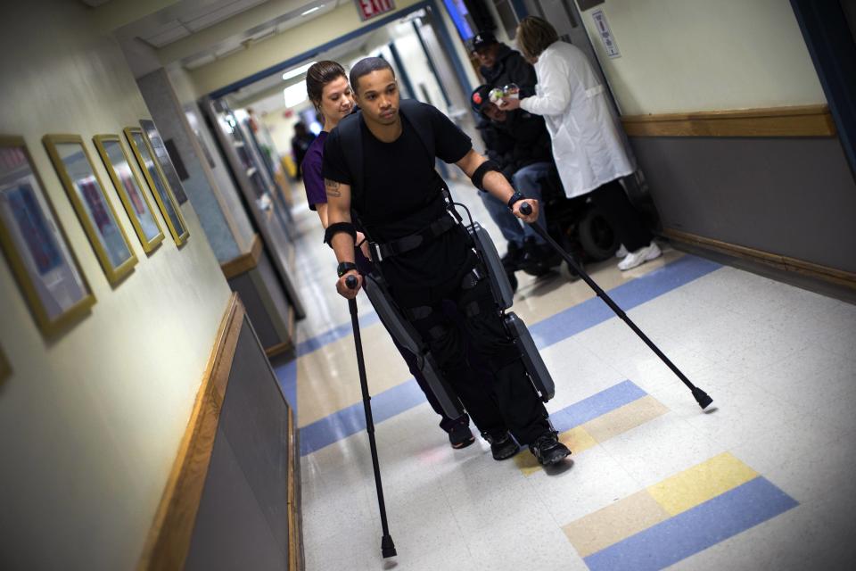 Samuels walks with ReWalk electric powered exoskeletal suit during a therapy session with Voigt at the Mount Sinai Medical Center in New York City