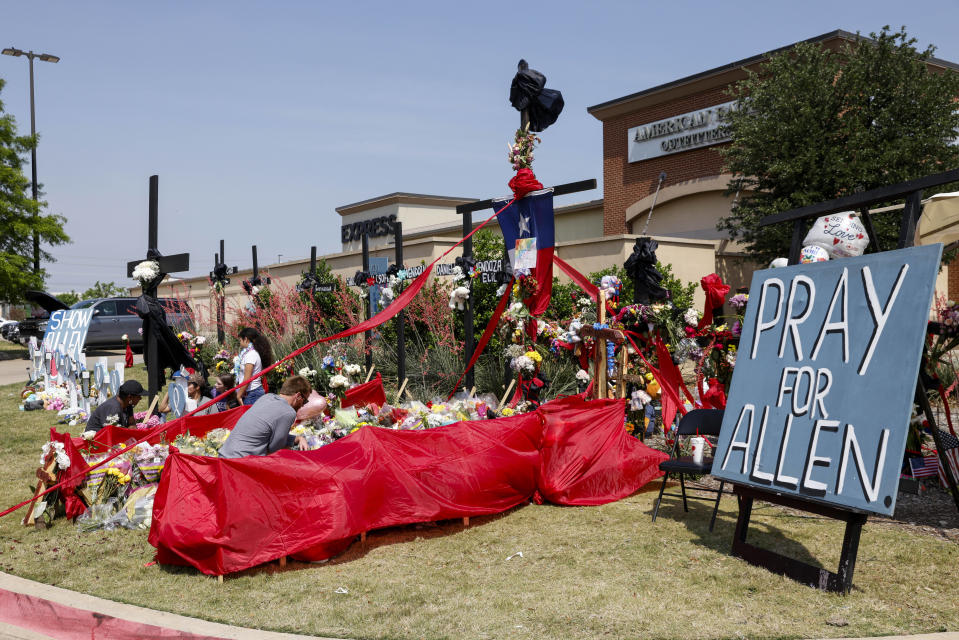 FILE - People place flowers and pay their respects at a memorial for victims of the Allen Premium Outlets mass shooting, May 9, 2023, in Allen, Texas. Misleading claims about the gunman who killed eight people at a Dallas-area shopping center are swirling on Twitter, thanks in part to the platform's owner, Elon Musk. Musk has questioned the gunman's self-professed white supremacist views, and said they could be part of a “psychological operation” to mislead the public. (Elías Valverde II/The Dallas Morning News via AP, file )