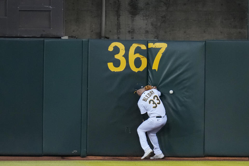 Oakland Athletics right fielder JJ Bleday is unable to make the play on a double hit by Texas Rangers' Jonah Heim during the seventh inning of a baseball game in Oakland, Calif., Thursday, May 11, 2023. (AP Photo/Godofredo A. Vásquez)