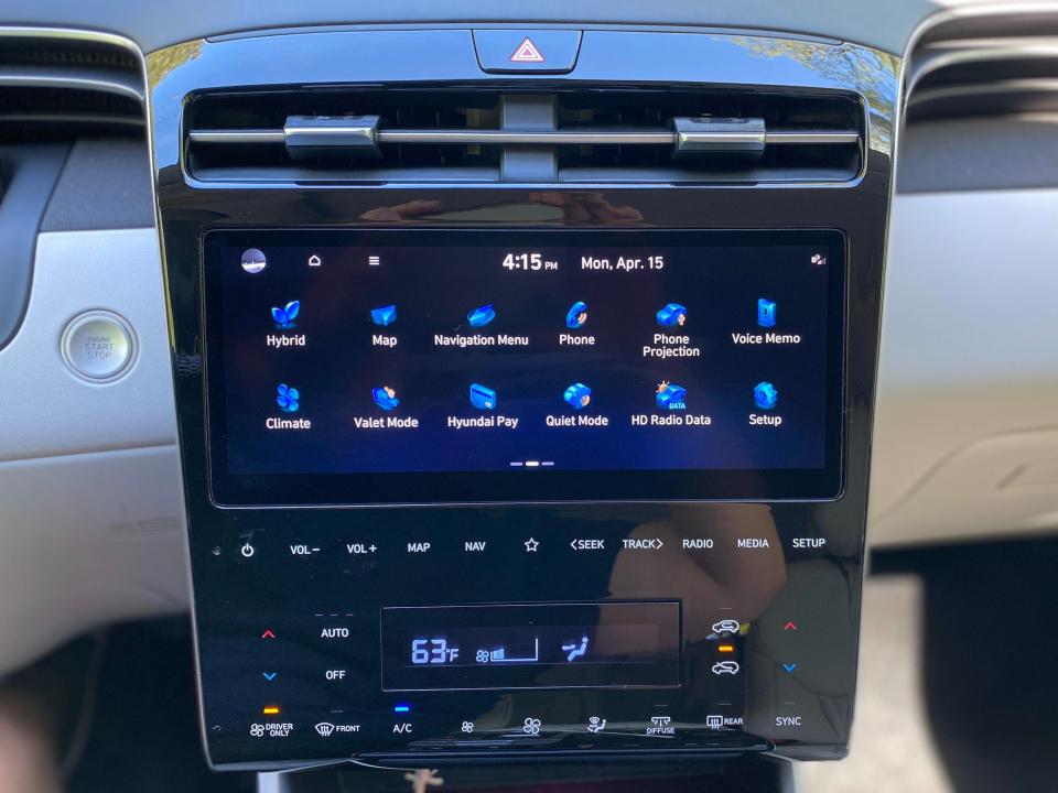 A 2024 Hyundai Tucson Hybrid's center console with a 10.25-inch touchscreen infotainment screen and touch-sensitive climate controls.