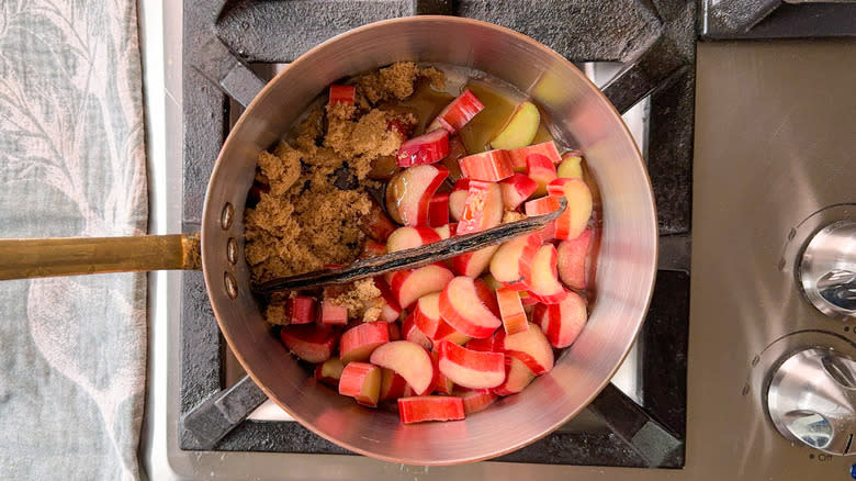 Rhubarb, vanilla bean, and brown sugar in saucepan on stovetop